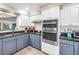 Well-equipped kitchen with stainless steel appliances, granite countertops, and white cabinets at 742 45Th Ne Ave, St Petersburg, FL 33703