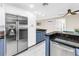 Modern kitchen with stainless steel appliances, granite counters, and a view into the living area at 742 45Th Ne Ave, St Petersburg, FL 33703