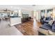 Open-concept living space featuring wood-look flooring, access to the kitchen and ample seating at 742 45Th Ne Ave, St Petersburg, FL 33703