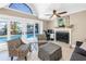 Living area with fireplace and sliding glass doors to the screened pool at 742 45Th Ne Ave, St Petersburg, FL 33703