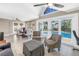 Living room with fireplace, seating and view to dining room and sliding glass doors to pool at 742 45Th Ne Ave, St Petersburg, FL 33703