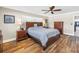 Spacious main bedroom featuring wood floors, a ceiling fan, and ensuite bathroom at 742 45Th Ne Ave, St Petersburg, FL 33703