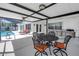 Covered patio featuring an outdoor dining set, counter with a grill, and an easy access to the pool at 742 45Th Ne Ave, St Petersburg, FL 33703