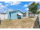 Backyard with a trampoline and view of the home's exterior, featuring blue siding at 7426 Cay Dr, Port Richey, FL 34668