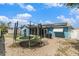 Backyard with trampoline, grill, and solar panels, surrounded by a white fence at 7426 Cay Dr, Port Richey, FL 34668