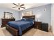 Spacious bedroom featuring a ceiling fan, carpeted floor, and stylish dark wooden furniture at 7426 Cay Dr, Port Richey, FL 34668