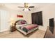 Bedroom featuring carpeted floors, a ceiling fan, and a comfortable bed with a wooden frame at 7426 Cay Dr, Port Richey, FL 34668