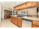 Spacious kitchen featuring a large island with breakfast bar and stainless steel dishwasher at 7426 Cay Dr, Port Richey, FL 34668