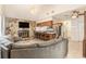 Cozy living room showcases stone fireplace, chandelier, and kitchen breakfast bar, ideal for relaxing and entertaining at 7426 Cay Dr, Port Richey, FL 34668