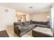 Comfortable living room with tiled floors, a large sectional sofa, and view to a connected dining area at 7426 Cay Dr, Port Richey, FL 34668