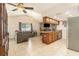Open-concept living space featuring a kitchen with breakfast bar and stone fireplace at 7426 Cay Dr, Port Richey, FL 34668