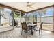 Enclosed patio area with outdoor dining set and view of trampoline and backyard at 7426 Cay Dr, Port Richey, FL 34668