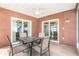 Covered patio area with a ceiling fan and sliding glass doors, and an outdoor dining set at 7426 Cay Dr, Port Richey, FL 34668