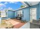 Charming front patio with brick flooring, wrought iron detailing, and comfortable seating for outdoor enjoyment at 7426 Cay Dr, Port Richey, FL 34668