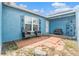 Cozy outdoor patio with brick pavers and seating area, perfect for relaxing or entertaining guests at 7426 Cay Dr, Port Richey, FL 34668