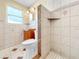 Cozy bathroom with tiled floors and walls, vanity with sink, toilet, and walk-in shower at 8210 68Th N Way, Pinellas Park, FL 33781