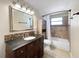 Cozy bathroom featuring a vanity with a dark countertop, standard tub, and updated lighting at 8210 68Th N Way, Pinellas Park, FL 33781