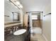 Well-lit bathroom featuring a dark vanity, updated lighting, a large mirror, and standard bathtub at 8210 68Th N Way, Pinellas Park, FL 33781