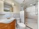 Well-lit bathroom features a tiled walk-in shower with built-in bench, updated vanity, and a standard toilet at 8210 68Th N Way, Pinellas Park, FL 33781