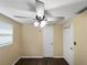 Bright room featuring a ceiling fan, wood floor, and standard-sized doors at 8210 68Th N Way, Pinellas Park, FL 33781