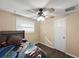 Bedroom with a ceiling fan, standard closet door, and a small window, providing natural light at 8210 68Th N Way, Pinellas Park, FL 33781