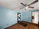 Bedroom featuring wood flooring, a ceiling fan, and a uniquely decorated door at 8210 68Th N Way, Pinellas Park, FL 33781