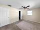Clean bedroom featuring neutral walls, a ceiling fan, and a spacious closet at 8210 68Th N Way, Pinellas Park, FL 33781
