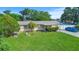 Charming single-story home with a well-maintained lawn and a blue car in the driveway at 8210 68Th N Way, Pinellas Park, FL 33781