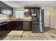 Kitchen featuring stainless steel appliances, dark cabinetry, and neutral backsplash at 8210 68Th N Way, Pinellas Park, FL 33781
