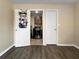 A laundry room featuring cabinet and shelving for storage, with wood flooring at 8210 68Th N Way, Pinellas Park, FL 33781