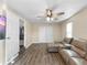 Comfortable living room with wood floors, a ceiling fan, and a large, comfortable sofa at 8210 68Th N Way, Pinellas Park, FL 33781