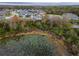 Aerial view captures the layout of homes with pools, and a pond at 8219 Summer Brook Ct, Land O Lakes, FL 34638