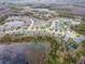 A community with an aerial view of houses surrounding small ponds, well manicured lawns and green spaces at 8219 Summer Brook Ct, Land O Lakes, FL 34638