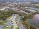 An aerial view of homes nestled near a scenic pond and lush green spaces offering serene community living at 8219 Summer Brook Ct, Land O Lakes, FL 34638