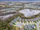 Large aerial view depicts a planned community, featuring lakes, numerous ponds, homes, and winding streets at 8219 Summer Brook Ct, Land O Lakes, FL 34638