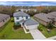 An aerial view showcasing a landscaped home with a pond in the backyard at 8219 Summer Brook Ct, Land O Lakes, FL 34638