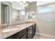 Luxurious bathroom featuring dual sinks, granite countertops, with a tiled shower and plenty of sunlight at 8219 Summer Brook Ct, Land O Lakes, FL 34638