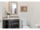 Stylish half bathroom featuring a granite countertop and decorative accents, plus a framed mirror at 8219 Summer Brook Ct, Land O Lakes, FL 34638