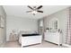 Comfortable bedroom featuring a white bed set, white walls, window, and light-colored furniture and decor at 8219 Summer Brook Ct, Land O Lakes, FL 34638