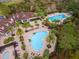 Areal view of the clubhouse and pools, featuring a resort-style atmosphere amidst lush landscaping at 8219 Summer Brook Ct, Land O Lakes, FL 34638