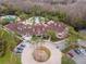 An aerial view showcasing a community clubhouse with swimming pools, lush landscaping, and parking at 8219 Summer Brook Ct, Land O Lakes, FL 34638