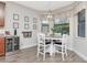 This bright dining area has a mini-fridge and shelving while overlooking the lush backyard at 8219 Summer Brook Ct, Land O Lakes, FL 34638