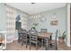 Dining room featuring modern light fixture, wooden table, and gray chairs at 8219 Summer Brook Ct, Land O Lakes, FL 34638