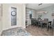 Dining room with wood-look tile and modern light fixture above the table at 8219 Summer Brook Ct, Land O Lakes, FL 34638