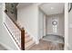 Inviting foyer with wood-look tile, staircase, and decorative glass front door at 8219 Summer Brook Ct, Land O Lakes, FL 34638