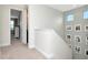 Upstairs hallway featuring carpet, wall decorations, small windows, and doorways that lead to bedrooms at 8219 Summer Brook Ct, Land O Lakes, FL 34638