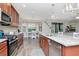 The kitchen features stainless steel appliances, granite countertops, and an open layout flowing into the dining area at 8219 Summer Brook Ct, Land O Lakes, FL 34638