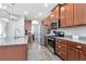 The kitchen has stainless steel appliances, granite countertops, and an open layout flowing into the dining area at 8219 Summer Brook Ct, Land O Lakes, FL 34638