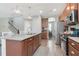 This kitchen features granite countertops, stainless steel appliances, and a view into an adjacent staircase at 8219 Summer Brook Ct, Land O Lakes, FL 34638