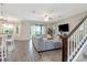Open-concept living room with wood-look tile flooring and comfortable seating at 8219 Summer Brook Ct, Land O Lakes, FL 34638